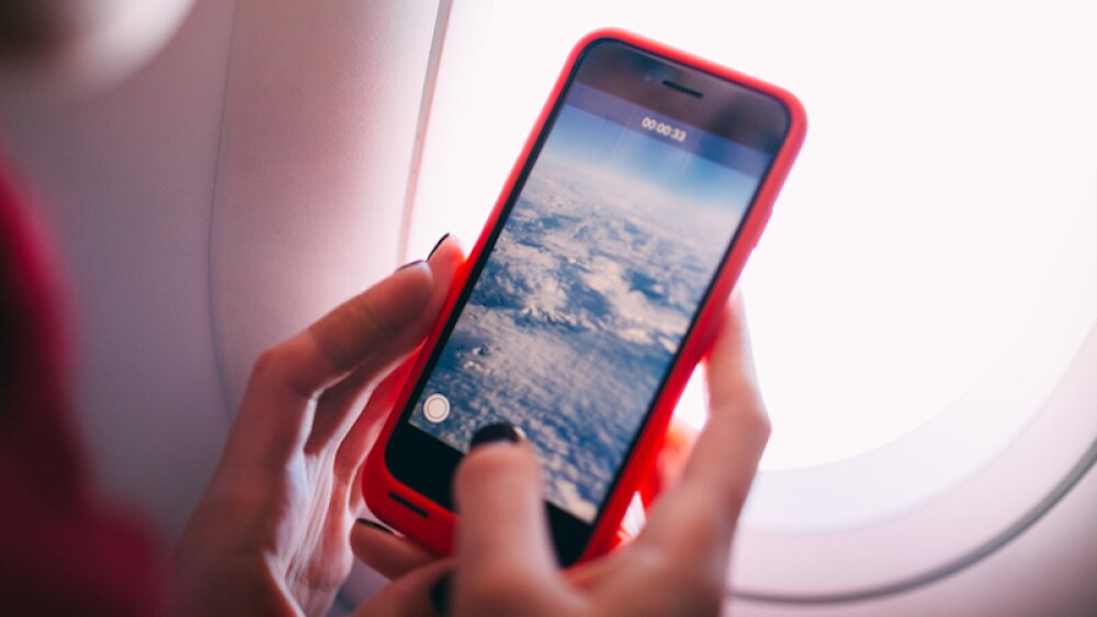 close-up of the hands of young woman recording a video by the smartphone