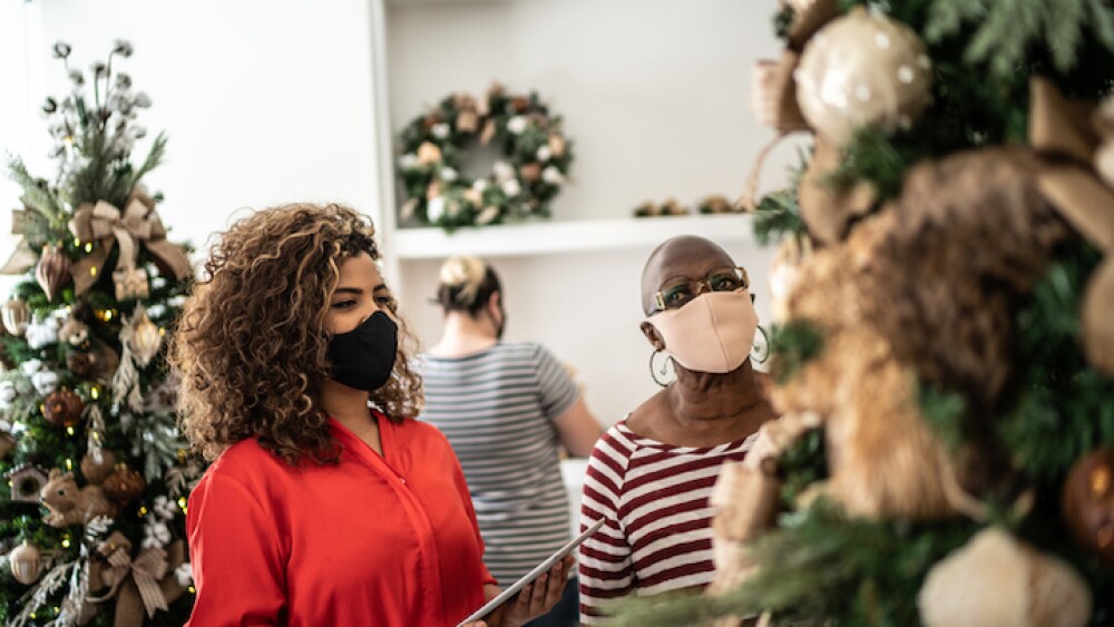 Saleswoman supporting a customer in a christmas ornament store